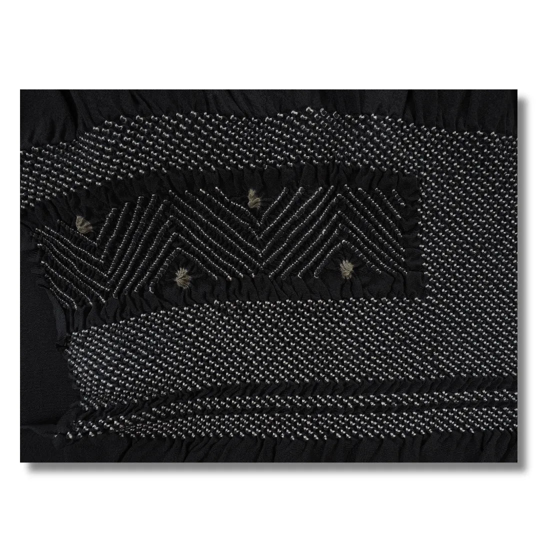 Nahaufnahme des Shibori-Zickzackmusters mit weißen Punkten und graugrünen Akzenten