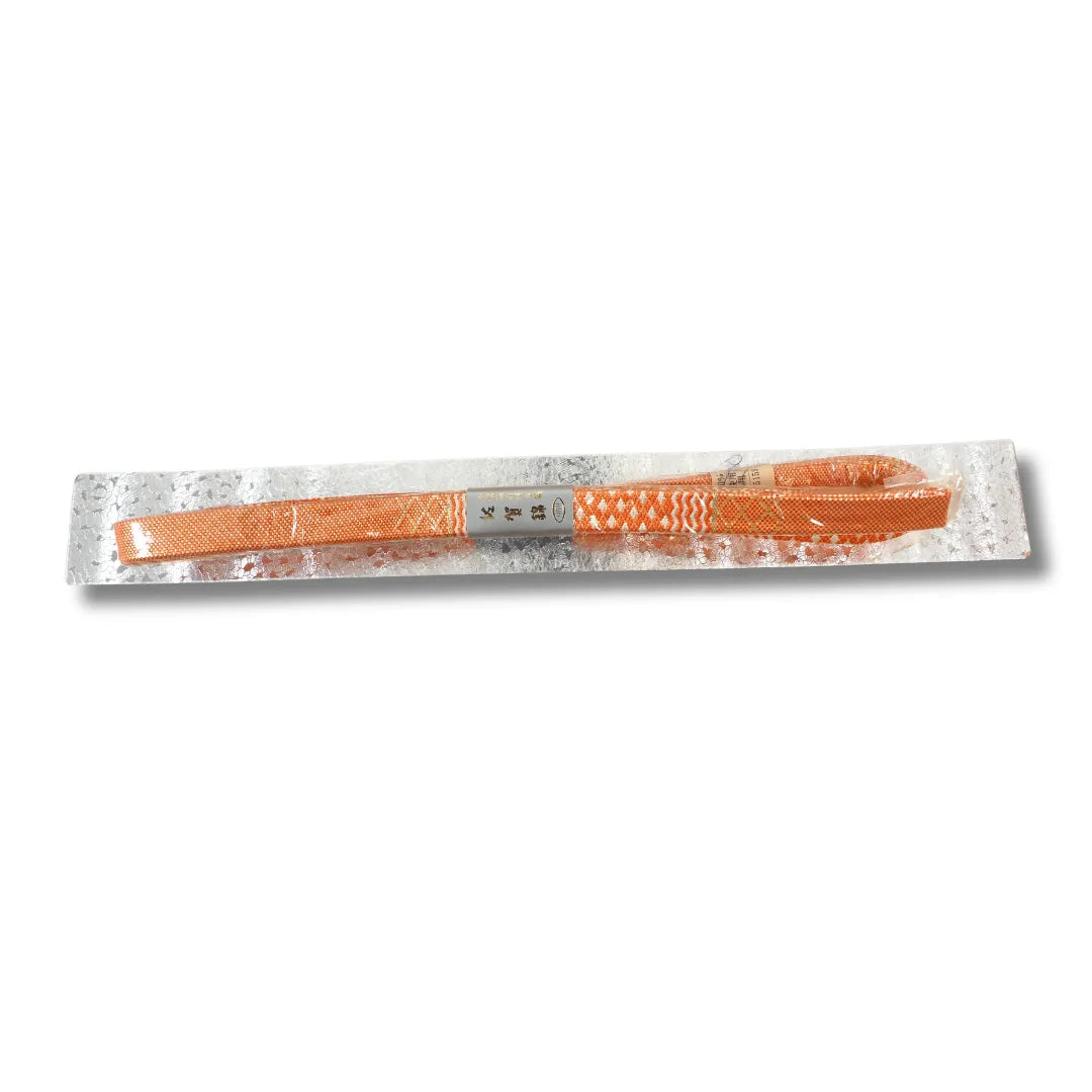 Originalverpackter Obijime in Orange auf silberner Pappe, Rauten- und Wellenmuster von oben