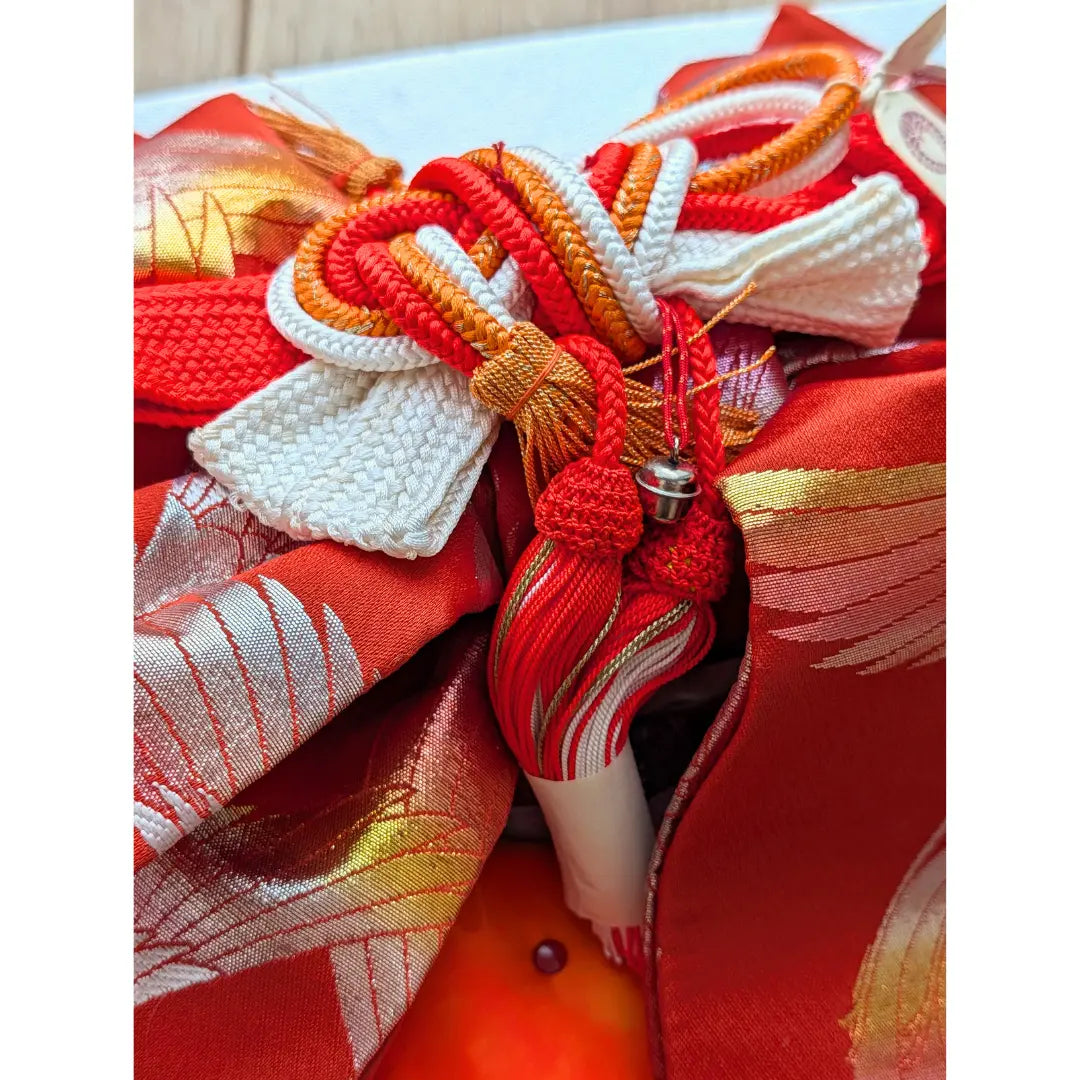 Quasten Vintage Musubi Obi Schleife in Rot mit Kranich-Muster und dekorativen Kordeln.