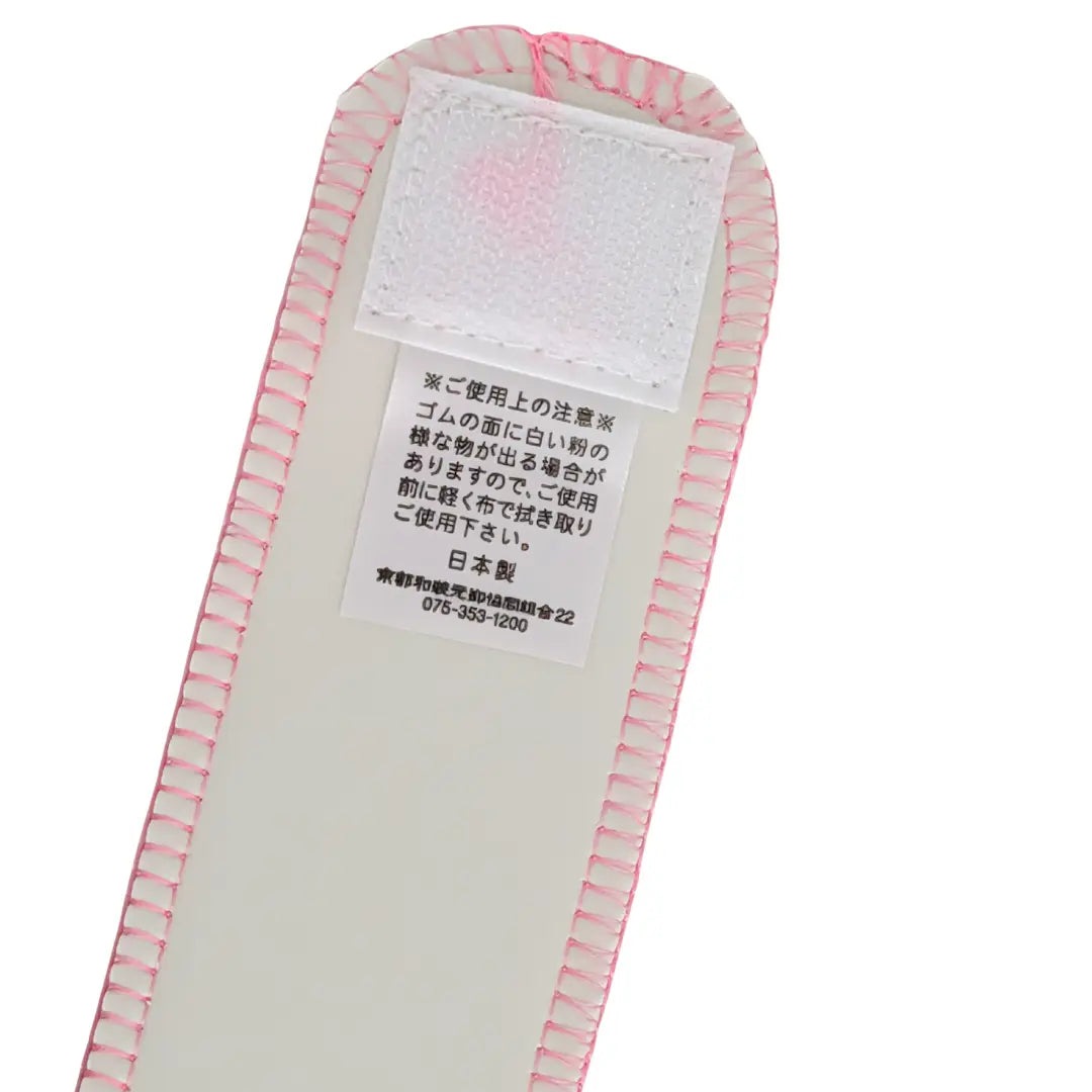Detail des Klettverschlusses am rosa Datejime Magic Belt mit japanischem Pflegehinweis