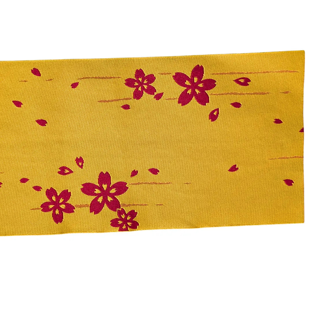 Goldgelbe Seite des Vintage Hanhaba Obi mit verstreuten Sakura-Blüten.